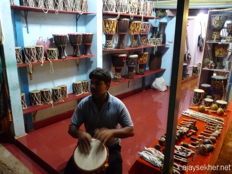Beating the recession blues: A musician from Rajasthan selling his instruments on the cliff at Varkala.
