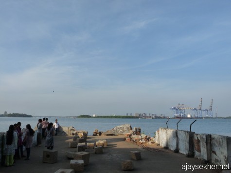 Where nature, art and people meet:  props of Sheela Gowda's stone installation projecting into the Aspinwall dock beside the ship channel in Fort Kochi.