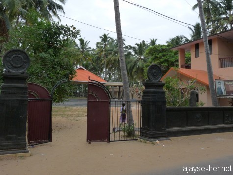 The gateway of Asan memorial library and sculptural complex at Kayikara.  Siddha statue towards the right inside the wall.