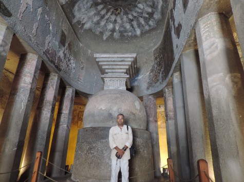 Before the Stupa in a Chaitya hall or cathedral at Ajanta.  Mark the apse, pillars and other cathedral architecture that was later recovered by European churches. 
