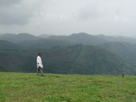 Pallykanam grasslands in Vagaman.  May 2013.  Anirudh walking through the grassland.  Also called Punjar Motta resonating the egg like top and the Stupa that once adorned the top.